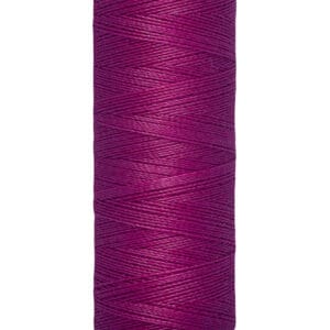A spool of Gütermann thread with bold magenta color, labeled 100 meters (110 yards). The spool is cream-colored with black text on the top and base.