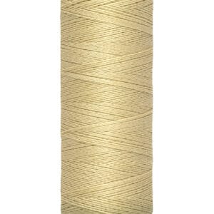Spool of Gütermann thread in a light beige color, labeled with a length of 100 meters or 110 yards. The label is cream-colored, with black text on the top and bottom.