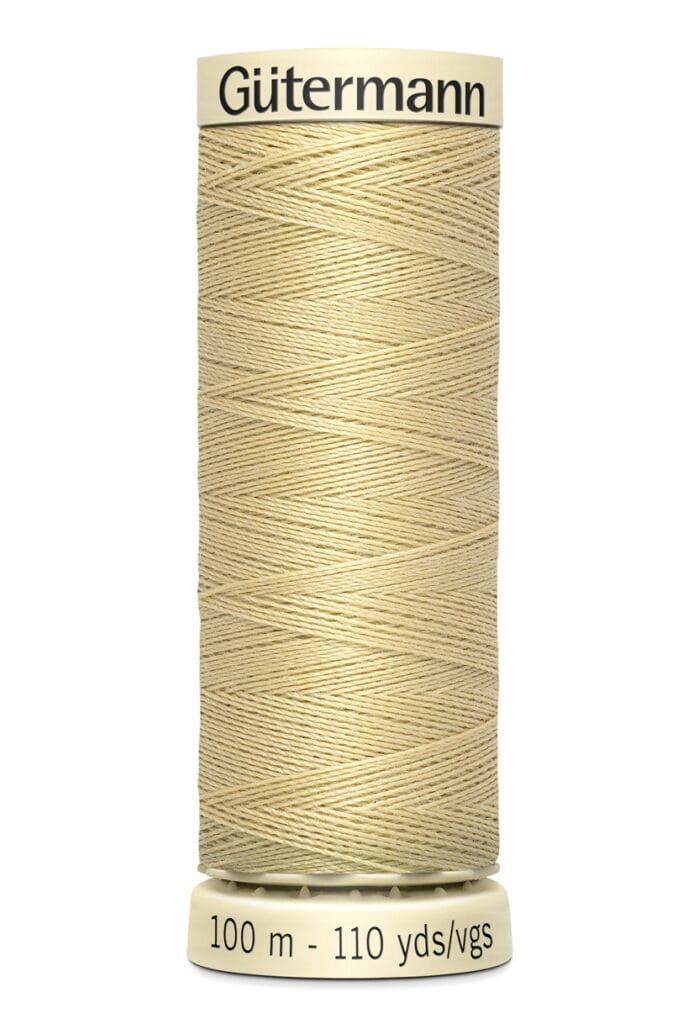 Spool of Gütermann thread in a light beige color, labeled with a length of 100 meters or 110 yards. The label is cream-colored, with black text on the top and bottom.