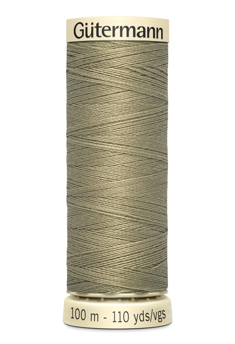 A spool of Gütermann sewing thread in a khaki color. The spool is labeled with "100 m - 110 yds/vgs" on the bottom. The thread is neatly wound around the spool.