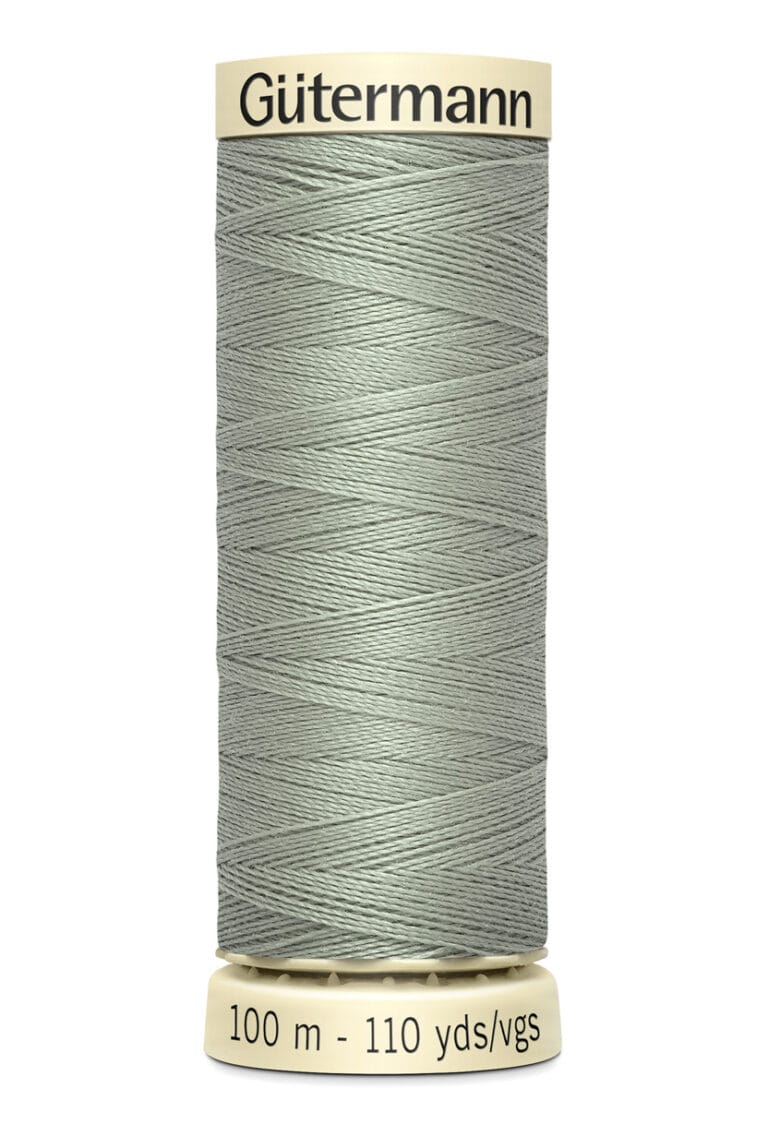 A spool of Gütermann sewing thread, light gray in color, with 100 meters (110 yards) indicated on the label. The spool is cylindrical with beige caps on top and bottom.