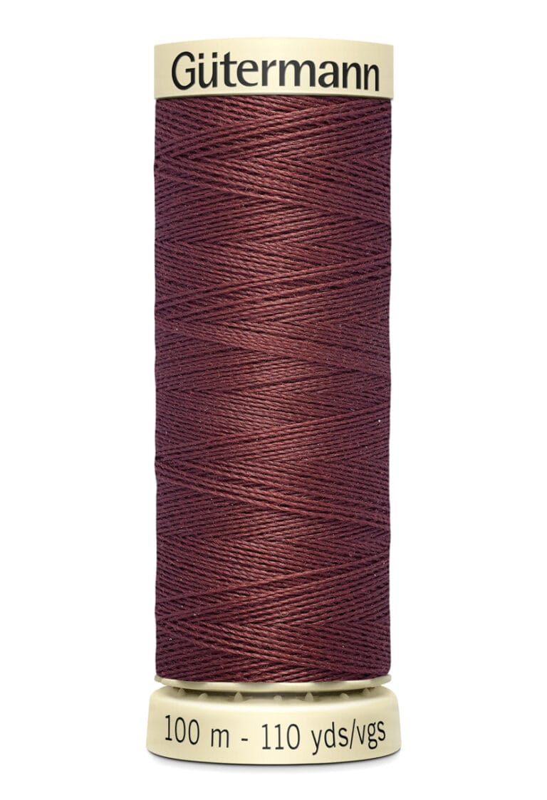 A spool of Gütermann thread in deep maroon color, wrapped neatly around a beige cylinder. The label displays the brand name and measures 100 meters or 110 yards.