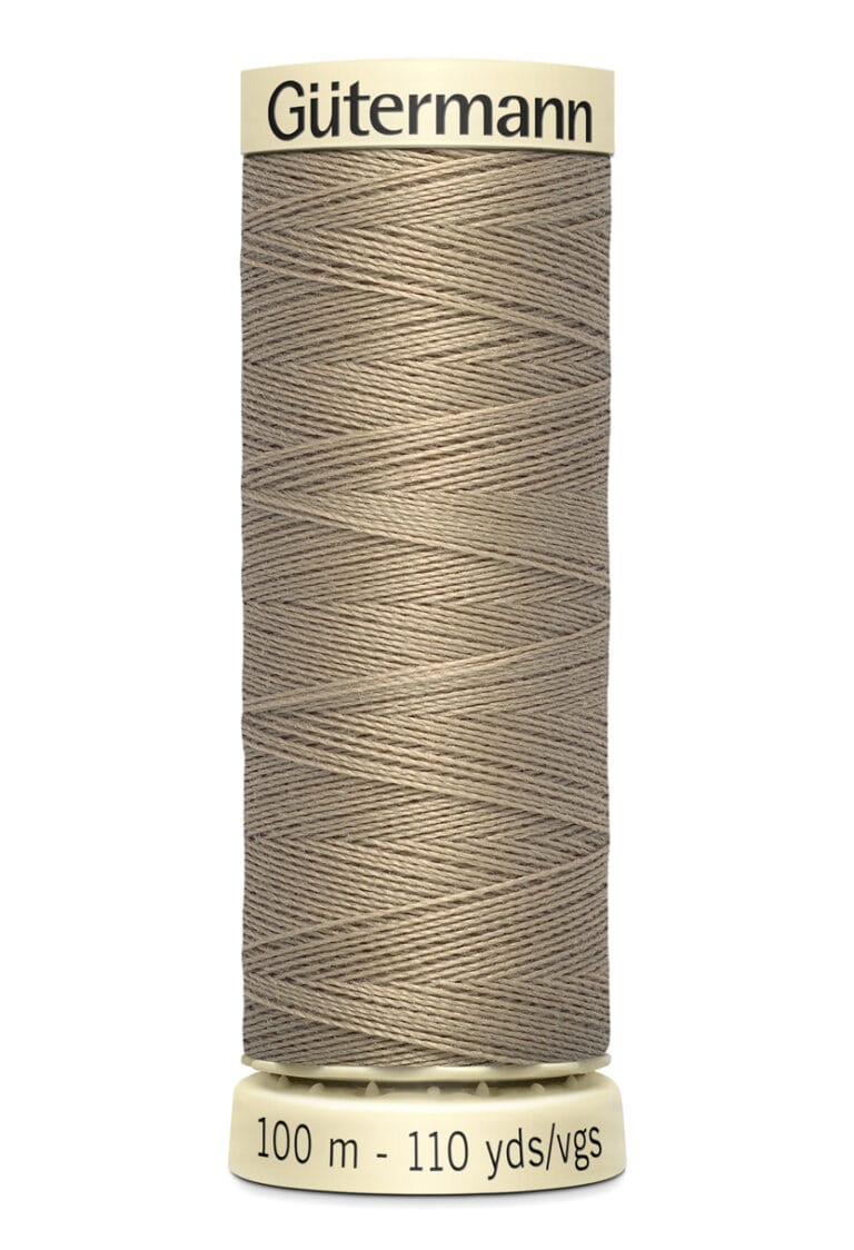 A spool of Gütermann sewing thread in a taupe color. The spool label indicates it contains 100 meters (110 yards) of thread. The thread is wound neatly in a crisscross pattern on a cream-colored plastic spool.