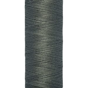 A spool of Gütermann thread in dark teal. The label indicates it is 100 meters or 110 yards long. The thread is tightly wound on a cream-colored spool with black text.