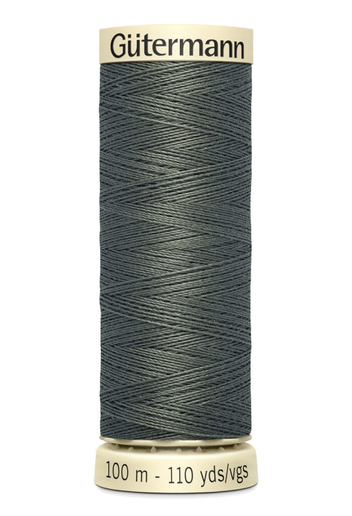 A spool of Gütermann thread in dark teal. The label indicates it is 100 meters or 110 yards long. The thread is tightly wound on a cream-colored spool with black text.