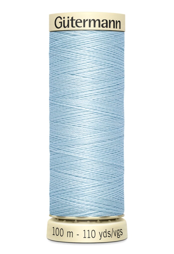 A spool of light blue Gütermann sewing thread on a beige base. The spool label indicates 100 meters and 110 yards. The brand name is visible at the top.