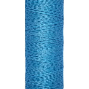 Spool of Gütermann thread in bright blue, labeled 100 meters - 110 yards/vgs, stands vertically against a white background.