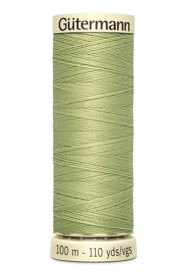 A spool of Gütermann sewing thread in light green sits upright. The thread is neatly wound on a beige spool, with label text indicating 100 meters and 110 yards.