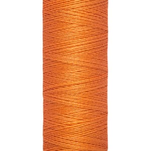 A spool of Gütermann thread in bright orange. The label indicates it contains 100 meters or 110 yards of thread. The spool is cylindrical with thread neatly wound around it.