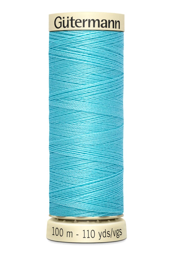 A spool of Gütermann sewing thread in bright turquoise color, labeled with 100 meters and 110 yards. The thread is neatly wound around a white cylindrical spool.