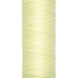 A spool of Gütermann sewing thread, pale yellow in color, stands upright. The label reads "100 m - 110 yds/vgs." The spool's top and bottom are beige.
