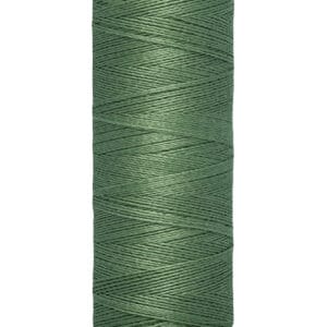 A spool of Gütermann sewing thread in green, tightly wound on a cream-colored base. The label reads "Gütermann" at the top and "100 m - 110 yds/vgs" at the bottom.
