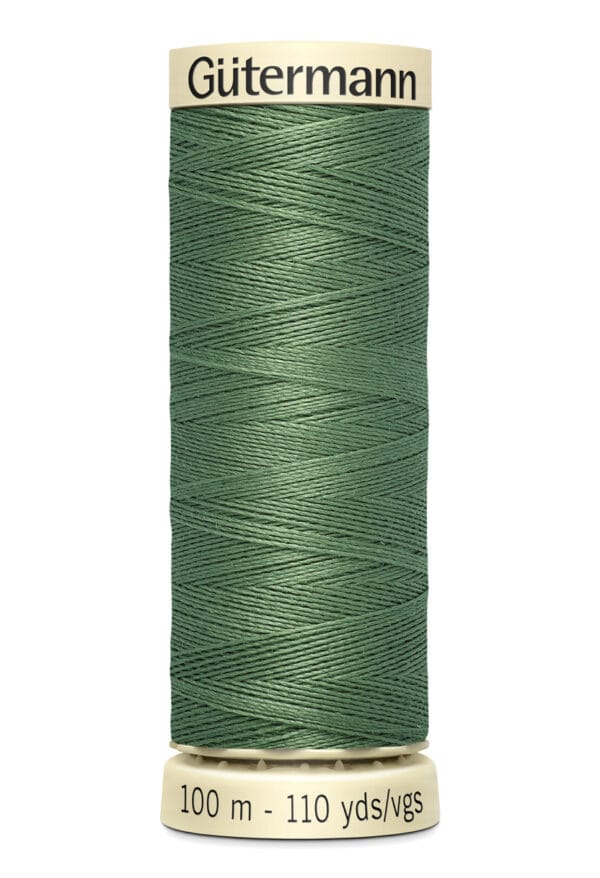 A spool of Gütermann sewing thread in green, tightly wound on a cream-colored base. The label reads "Gütermann" at the top and "100 m - 110 yds/vgs" at the bottom.