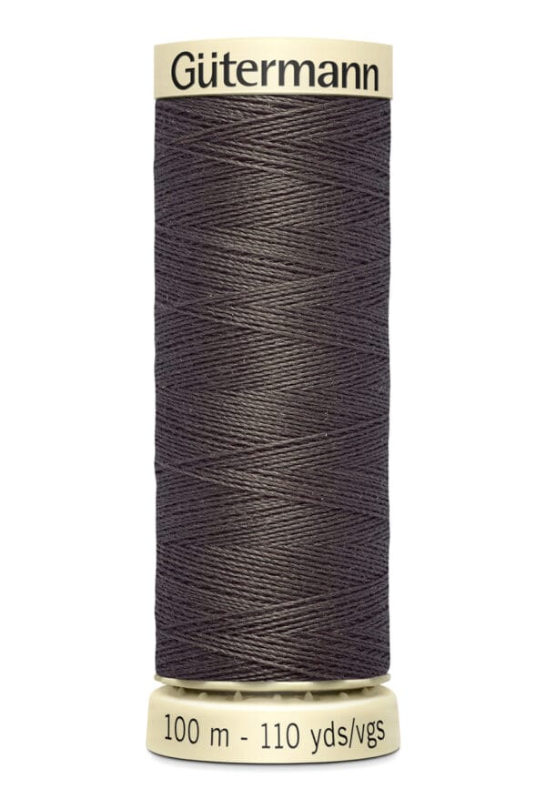 A spool of Gütermann thread in dark brown color, holding 100 meters or 110 yards of thread. The spool has a beige top and bottom with black text indicating the brand and thread length.