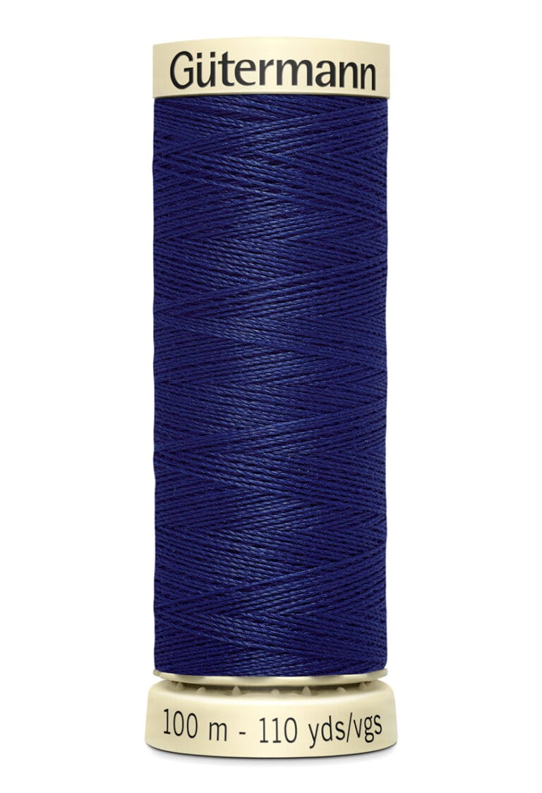 A spool of Gütermann sewing thread in dark blue, with a beige top and bottom. The label reads "100 m - 110 yds/vgs.