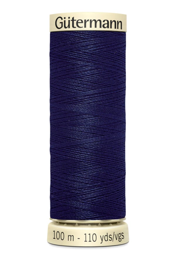 A spool of Gütermann thread, featuring dark blue thread wrapped around a cream-colored holder. The label indicates 100 meters (110 yards).