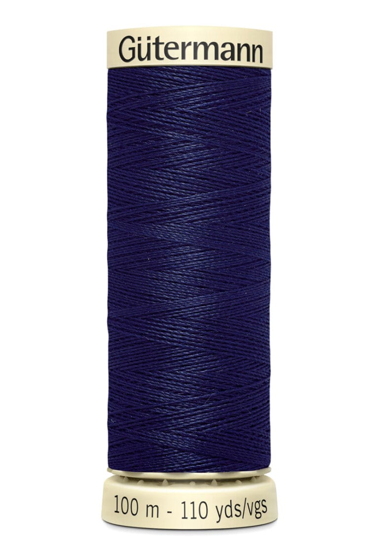 A spool of Gütermann thread, featuring dark blue thread wrapped around a cream-colored holder. The label indicates 100 meters (110 yards).