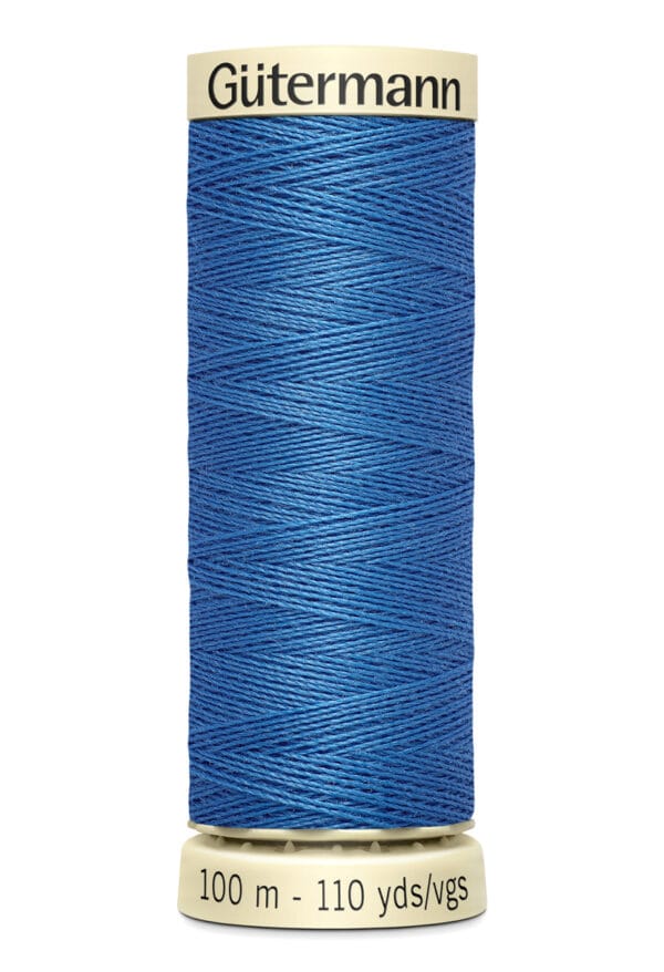 A spool of Gütermann blue sewing thread, wrapped around a beige cylindrical holder. The label reads "Gütermann" at the top and "100 m - 110 yds" at the bottom. The thread is neatly wound and vibrant blue in color.