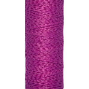 A spool of Gütermann thread in vibrant purple, labeled as 100 meters or 110 yards. The thread is neatly wound around a beige spool.