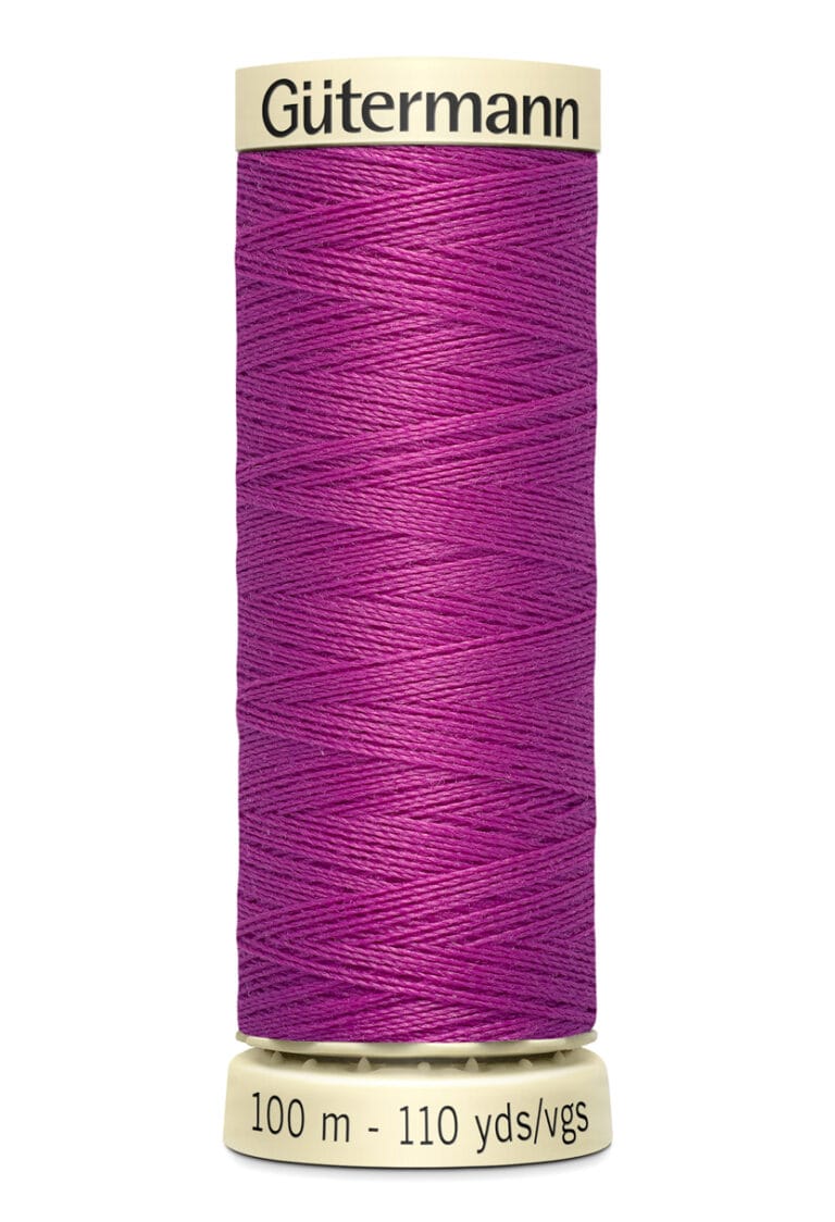 A spool of Gütermann thread in vibrant purple, labeled as 100 meters or 110 yards. The thread is neatly wound around a beige spool.