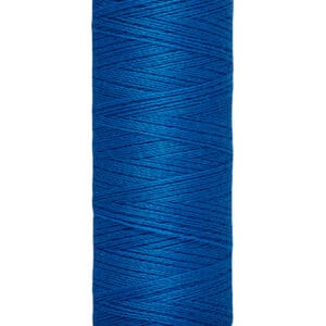 A spool of Gütermann blue sewing thread with a beige top and bottom cap. The label reads "100 m - 110 yds/vgs.