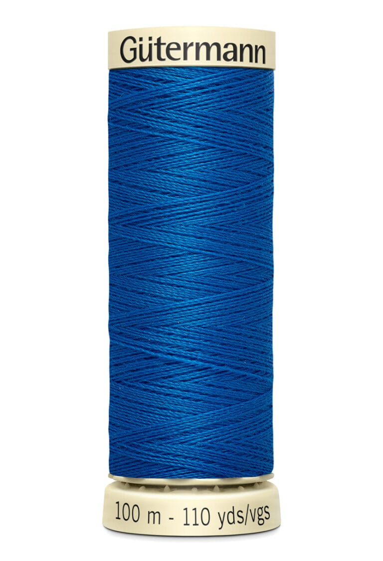 A spool of Gütermann blue sewing thread with a beige top and bottom cap. The label reads "100 m - 110 yds/vgs.