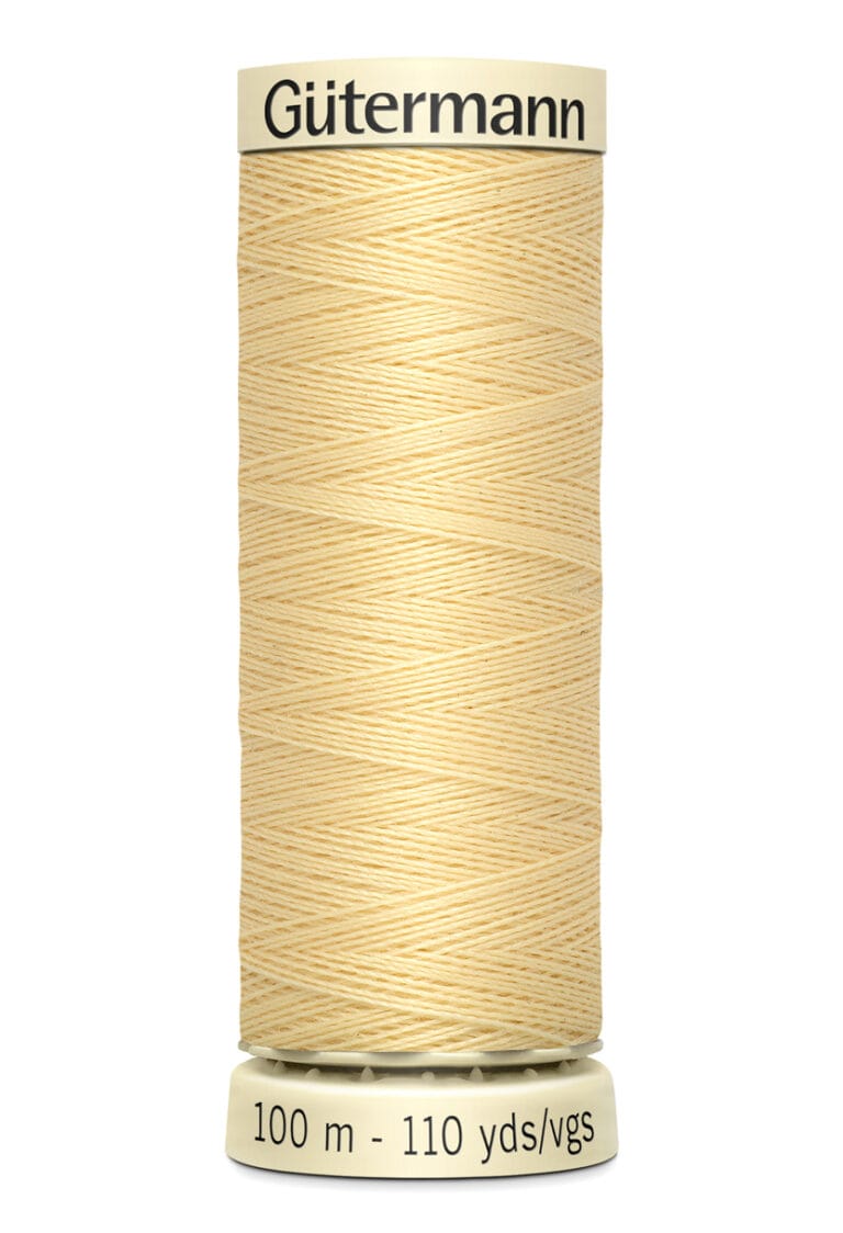 A spool of Gütermann thread in light yellow color, labeled with "100 m - 110 yds/vgs" indicating its length. The spool is upright with the brand name visible at the top.