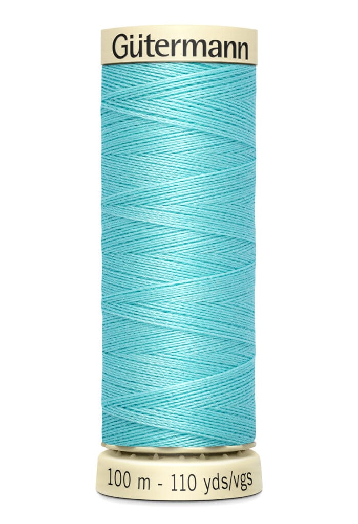 Spool of Gütermann thread in light blue, labeled with "100 m - 110 yds/vgs.