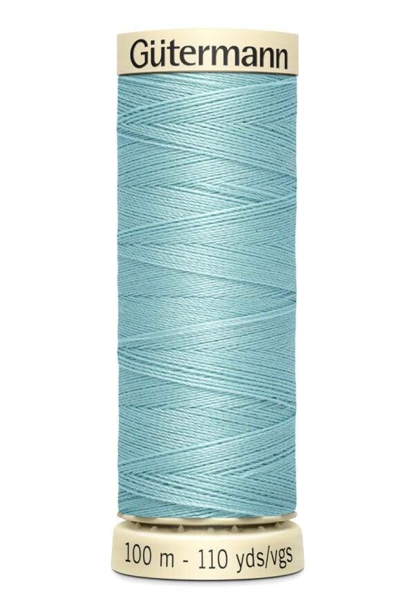 A spool of Gütermann thread in light blue, with a length of 100 meters or 110 yards. The spool has a beige top and bottom, and the brand name is printed on the top.