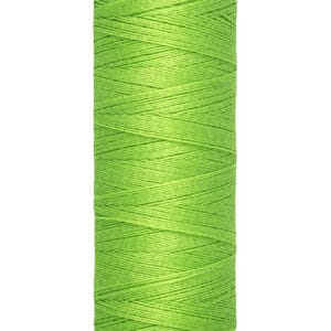A spool of Gutermann sewing thread in bright green. The spool is labeled with "100m - 110 yds/vgs" and features a contrasting beige top and bottom. The thread is neatly wound around the spool.