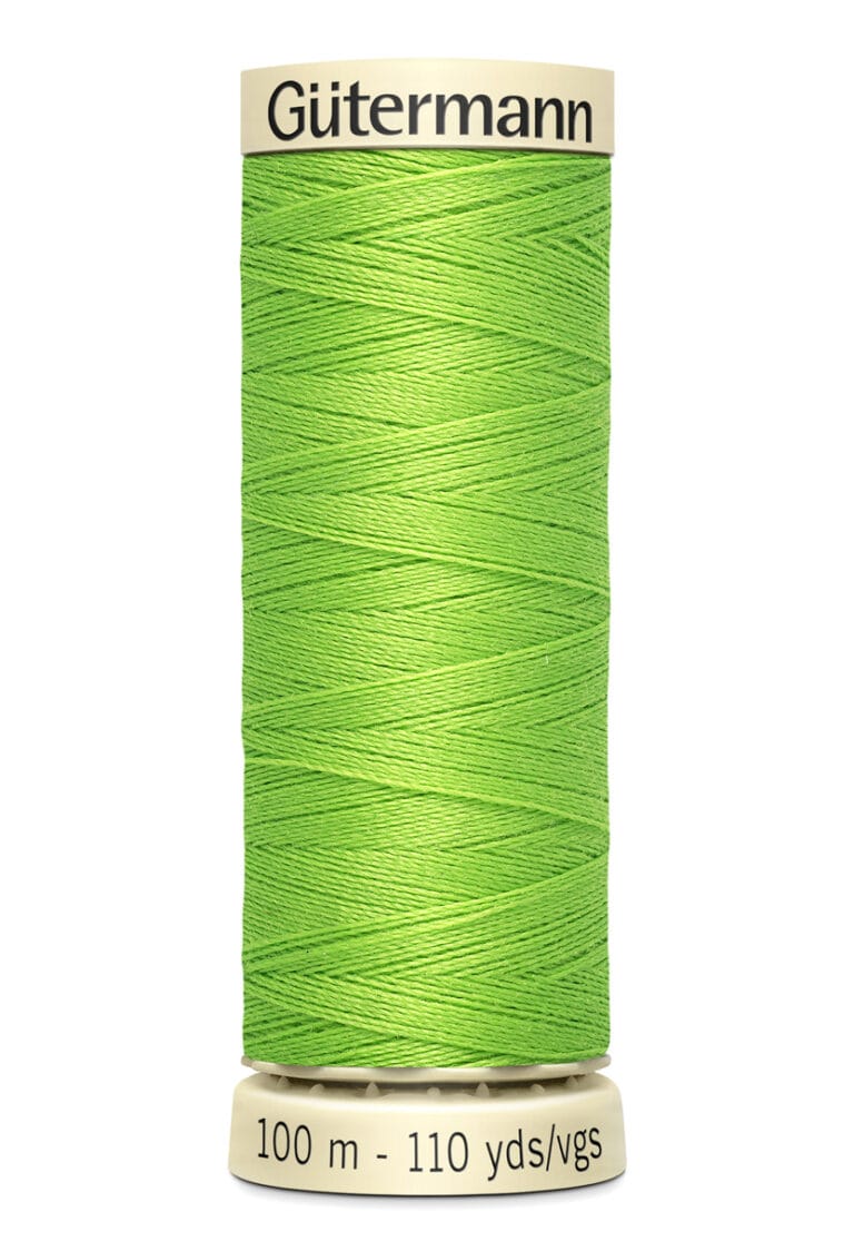 A spool of Gutermann sewing thread in bright green. The spool is labeled with "100m - 110 yds/vgs" and features a contrasting beige top and bottom. The thread is neatly wound around the spool.