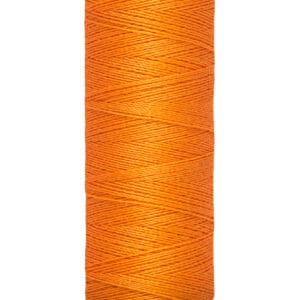 A spool of Gütermann orange thread with a beige top and base. The text on the base indicates it contains 100 meters or 110 yards of thread.