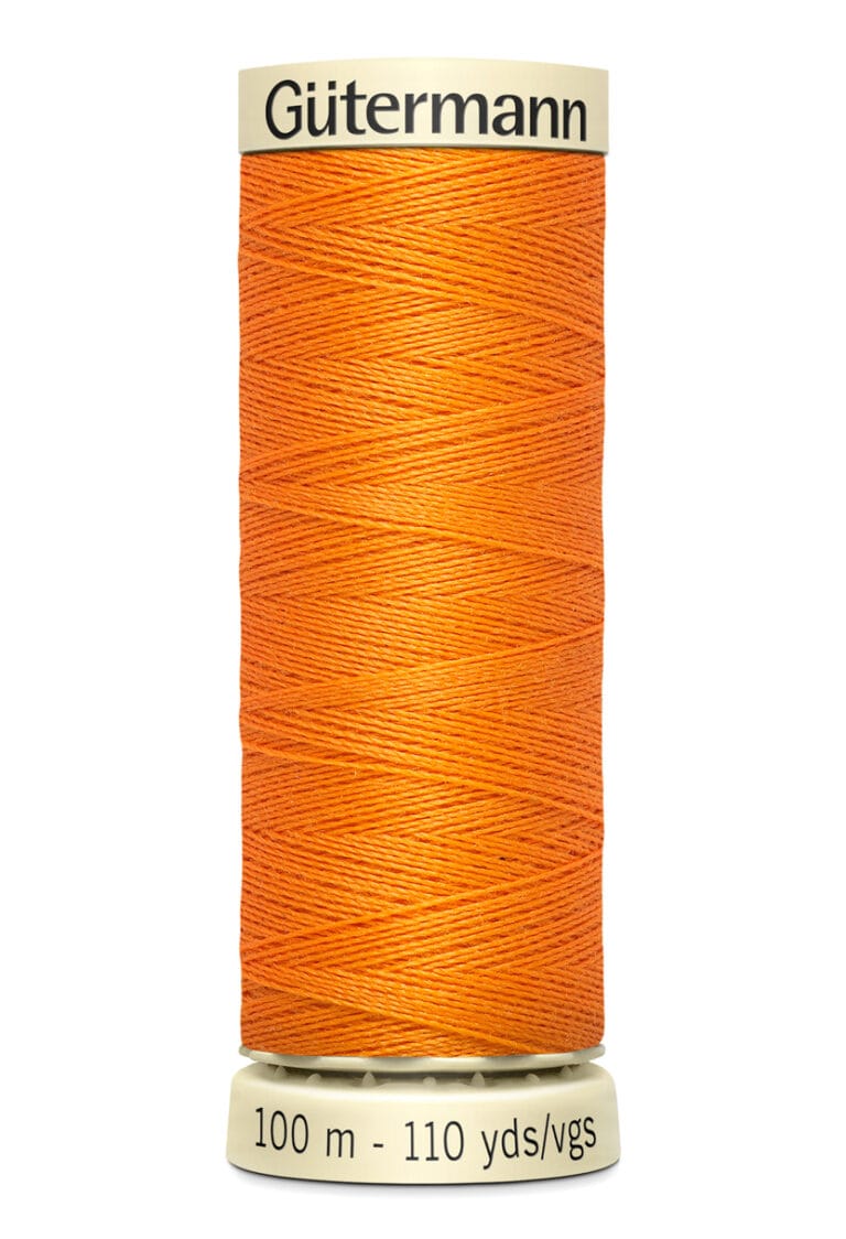 A spool of Gütermann orange thread with a beige top and base. The text on the base indicates it contains 100 meters or 110 yards of thread.