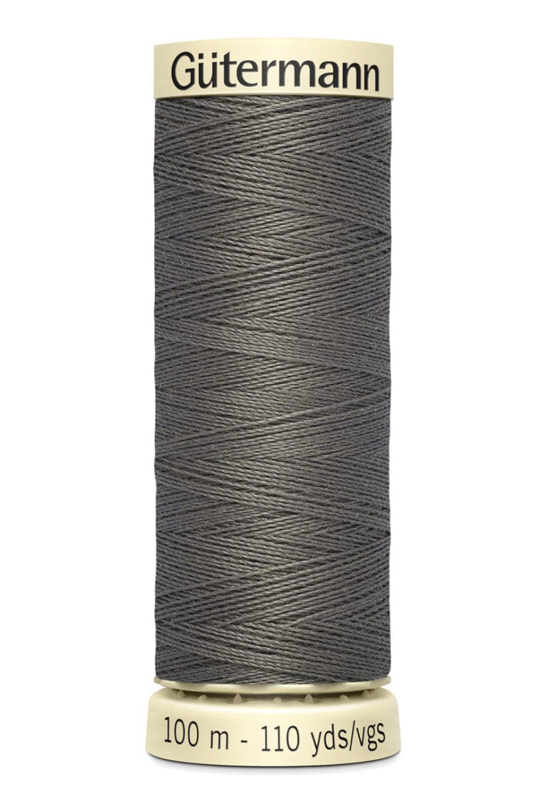 A spool of Gütermann thread in dark gray color, labeled with "100 m - 110 yds" at the bottom. The thread is neatly wound around a beige cylinder with the brand name displayed at the top.