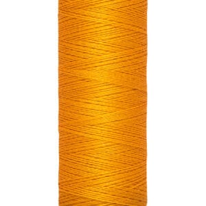 Spool of Gütermann orange thread, labeled with "100 m - 110 yds/vgs" at the base. The thread is neatly wound around the spool, creating a vivid contrast with the light-colored ends.