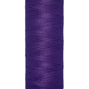 A spool of Gütermann sewing thread in a vibrant purple color. The label indicates the length as 100 meters or 110 yards. The thread is neatly wound on a beige spool.