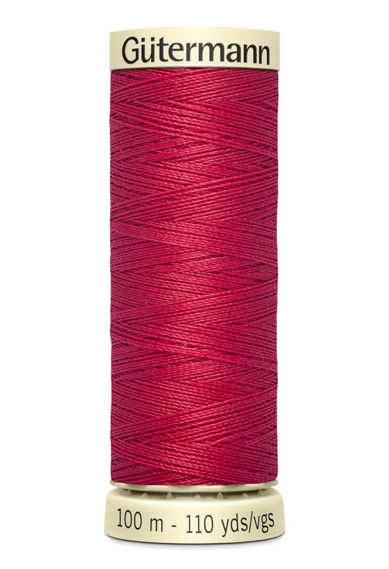 A spool of Gütermann red sewing thread. The label shows it contains 100 meters or 110 yards of thread.