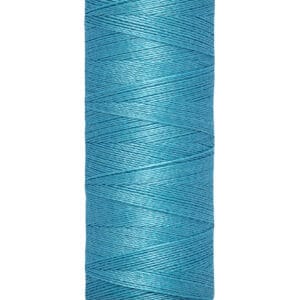 A spool of Gütermann sewing thread, turquoise in color, with a label indicating 100 meters and 110 yards. The spool has a beige top and bottom.