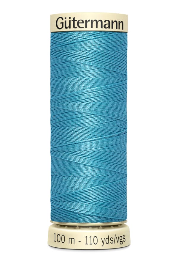 A spool of Gütermann sewing thread, turquoise in color, with a label indicating 100 meters and 110 yards. The spool has a beige top and bottom.
