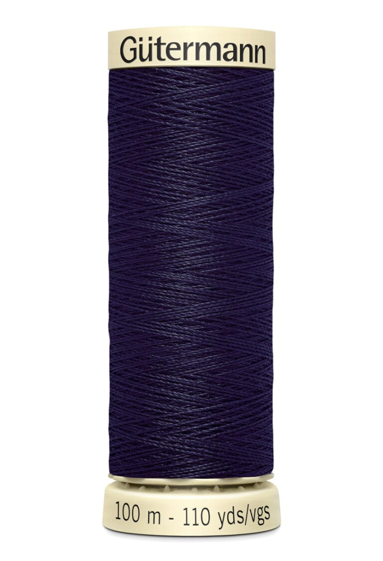 Spool of Gütermann sewing thread, deep blue color, labeled with "100 m - 110 yds." The spool is cylindrical with a beige top and bottom.