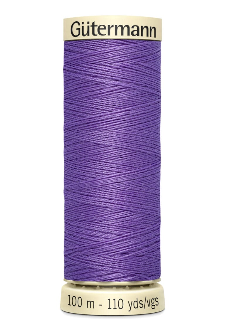 A spool of Gütermann thread, featuring vibrant purple thread. The spool has labels indicating 100 meters and 110 yards.