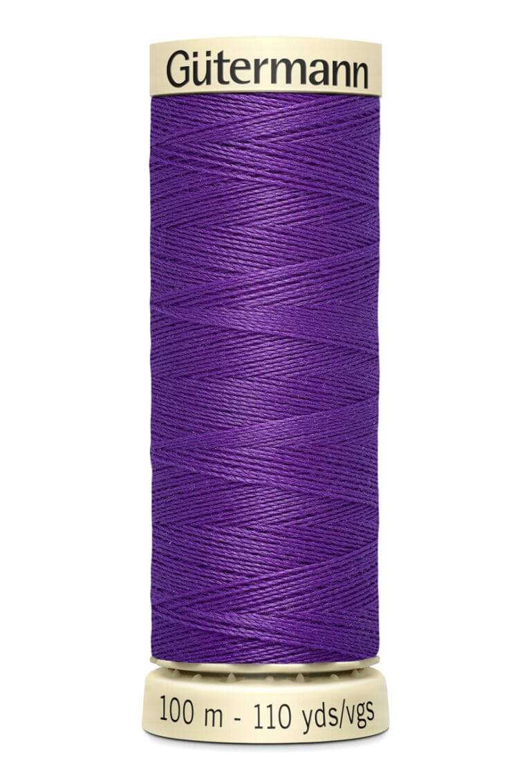 A spool of Gütermann thread with 100 meters (110 yards) of vibrant purple thread. The spool is beige with brand and measurement details printed on it.