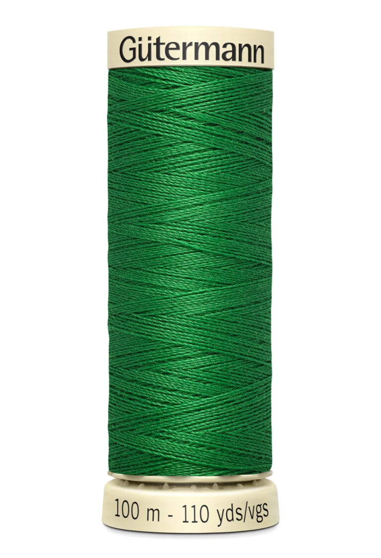 A spool of Gütermann green sewing thread with 100 meters or 110 yards capacity.