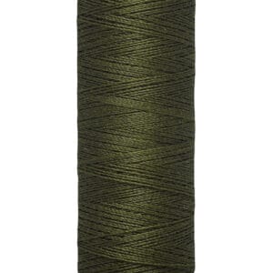 A spool of Gütermann thread in dark green, with labels displaying "100 m - 110 yds/vgs." The thread is neatly wound on a beige reel.