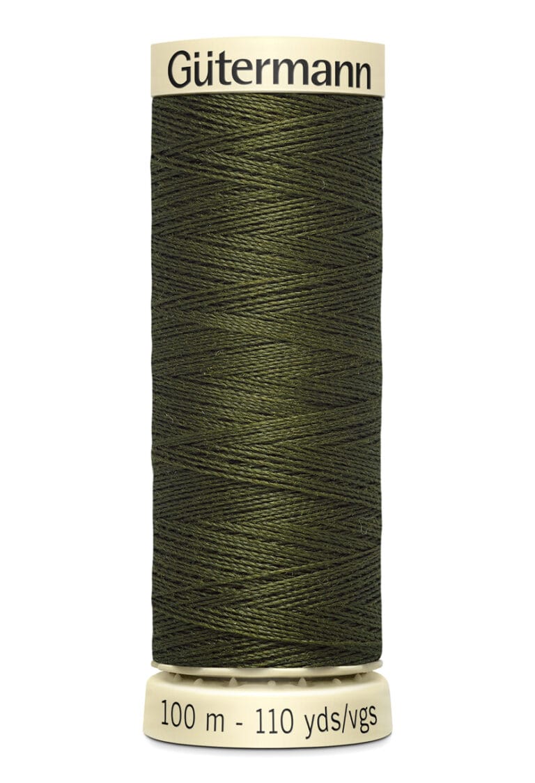 A spool of Gütermann thread in dark green, with labels displaying "100 m - 110 yds/vgs." The thread is neatly wound on a beige reel.