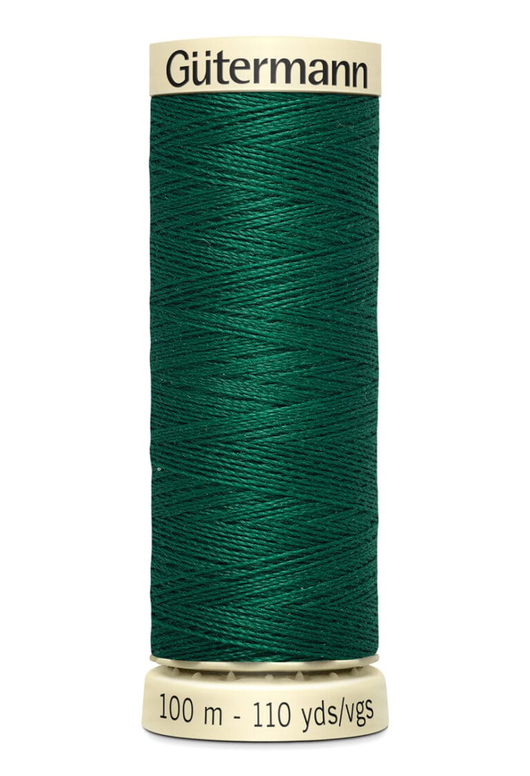 A spool of Gütermann sewing thread, 100 meters or 110 yards, in dark green. The thread is neatly wound around a beige spool with the brand name printed on the top.