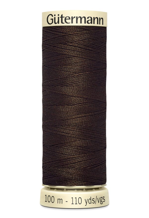 A spool of Gütermann sewing thread, featuring dark brown thread tightly wound around a cylindrical spool. The label displays "100 m - 110 yds/vgs.