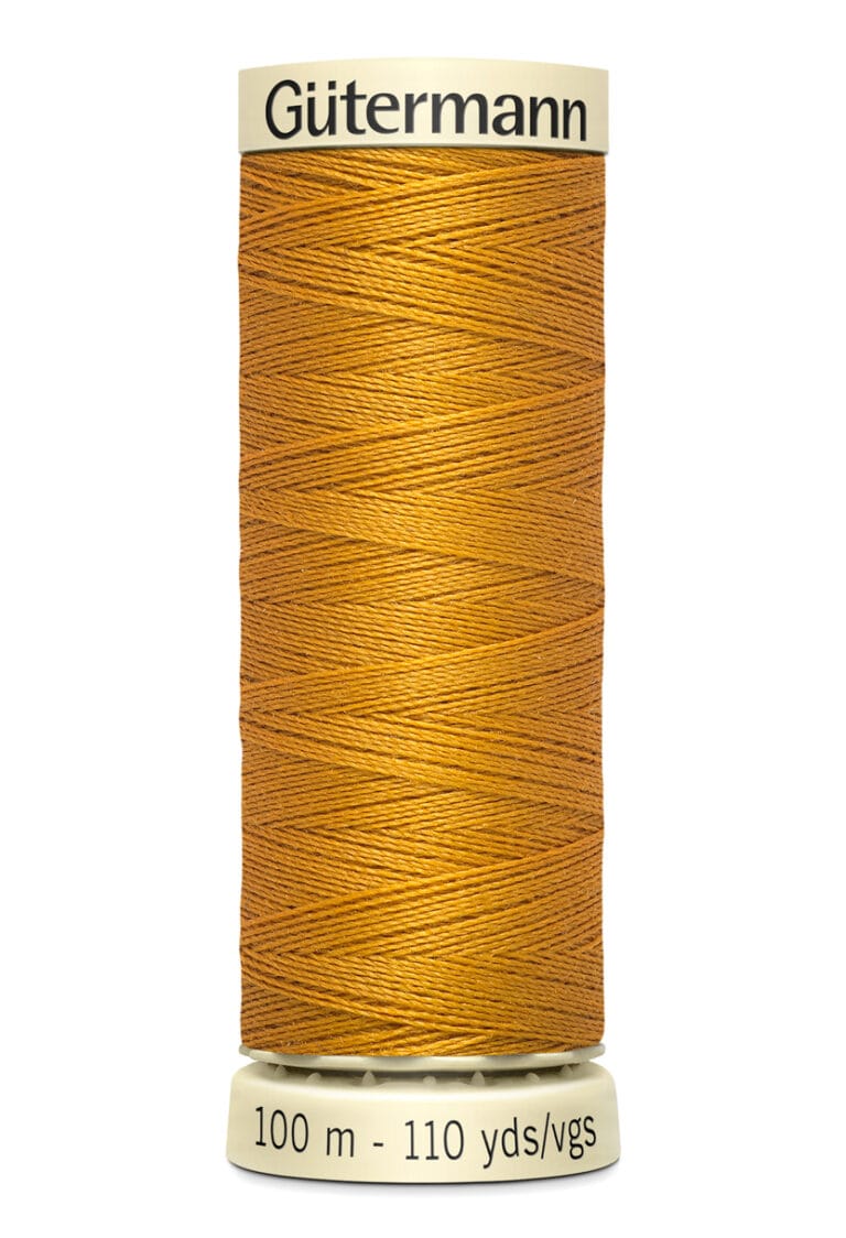 A spool of Gütermann sewing thread in a rich mustard yellow color. The spool is labeled with "100 m - 110 yds/vgs" and "Gütermann" at the top. The thread is neatly wound around the spool.