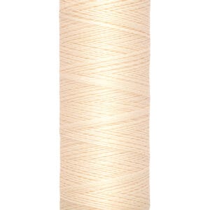 A beige spool of Gütermann sewing thread, labeled "100 m - 110 yds," with tightly wound strands. The top and bottom are cream-colored with brand and measurement info displayed in black text.