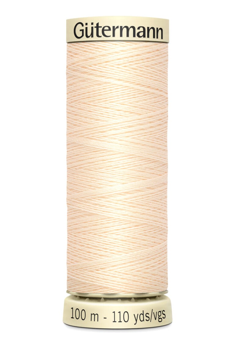 A beige spool of Gütermann sewing thread, labeled "100 m - 110 yds," with tightly wound strands. The top and bottom are cream-colored with brand and measurement info displayed in black text.